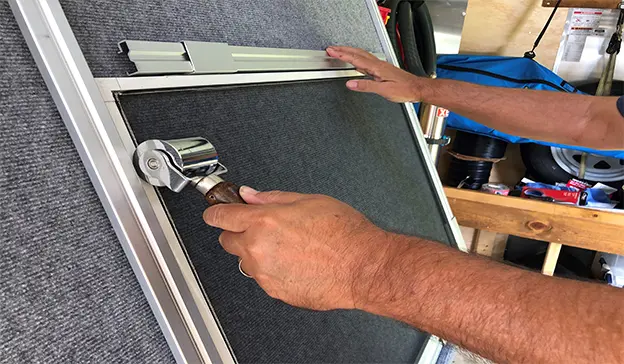 Technician rebuilding a screen frame